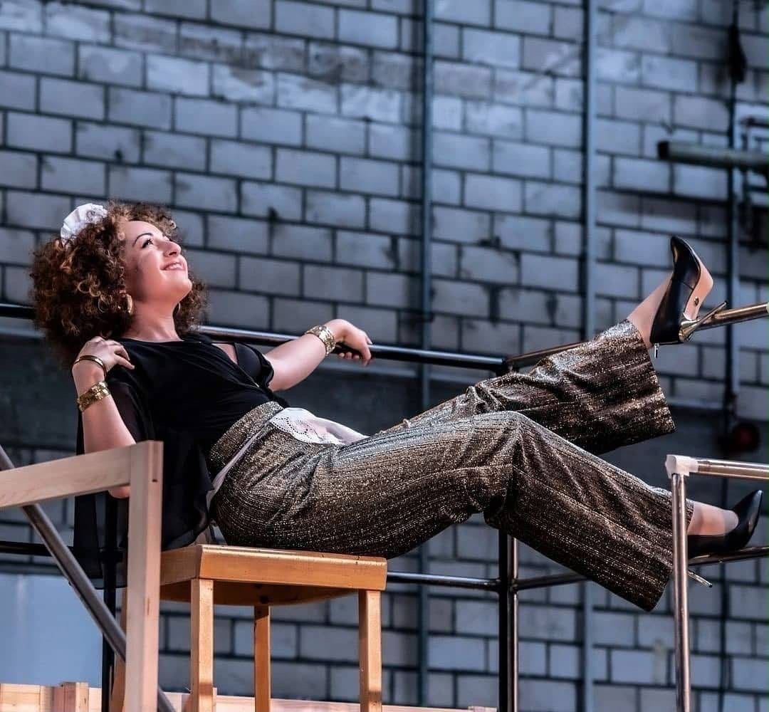 Laughing on stage in gold trousers